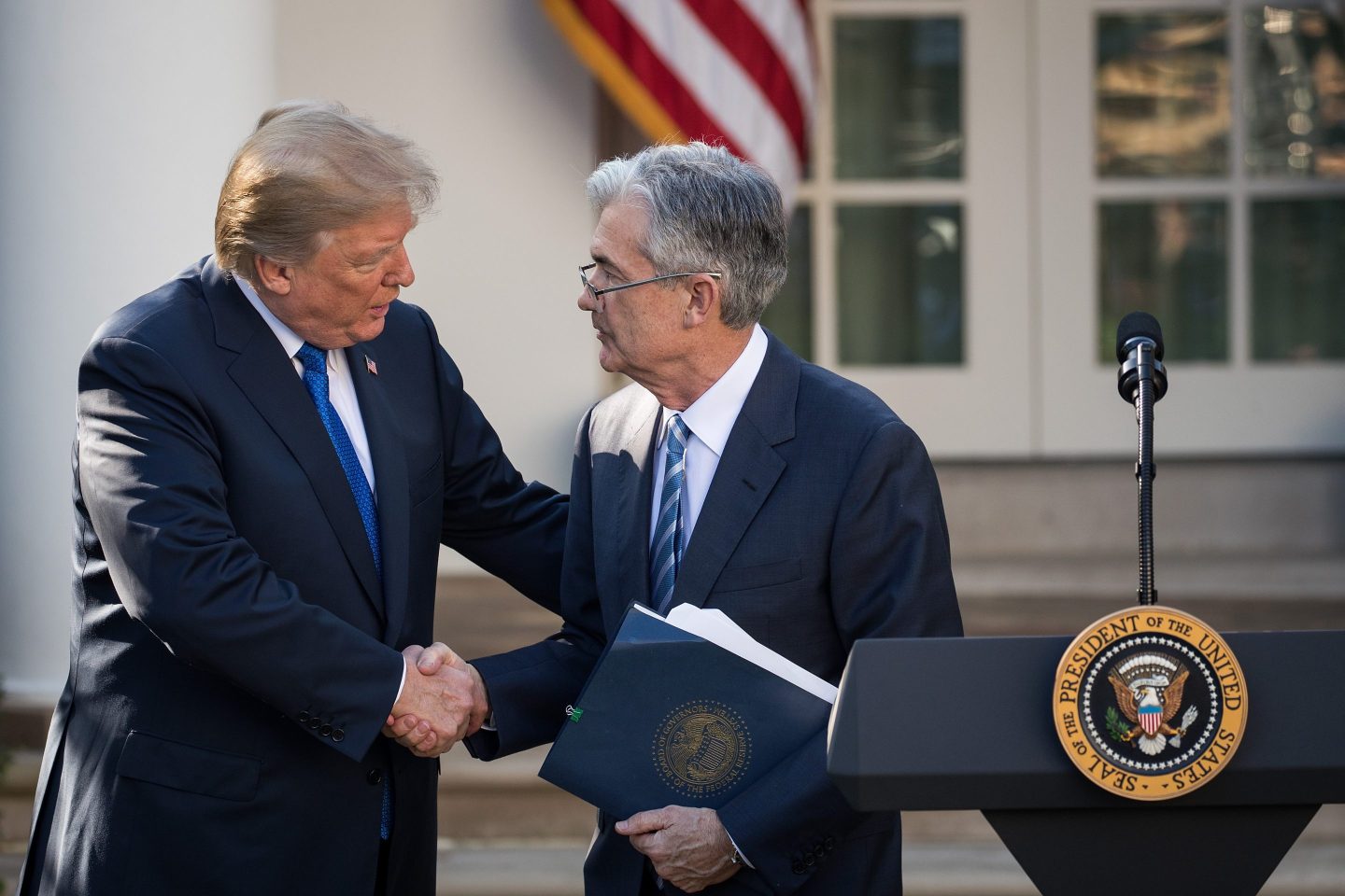 President Donald Trump shakes hands with Fed chairman Jerome Powell