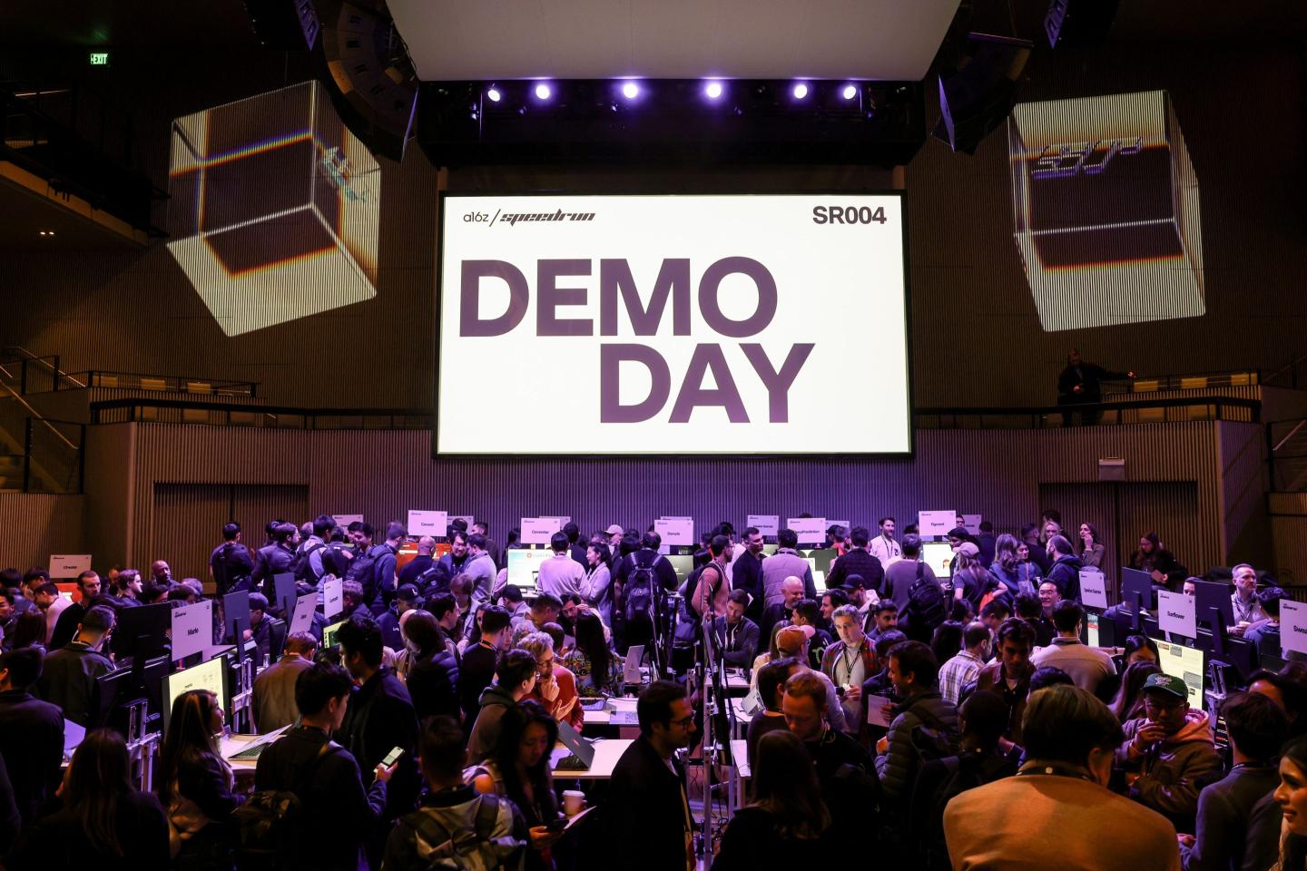 screen with words DEMO DAY and crowd gathered below