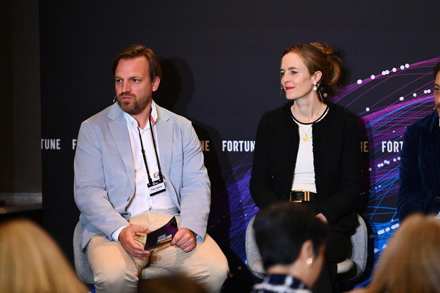 peter vanham and robyn scott sitting at a panel