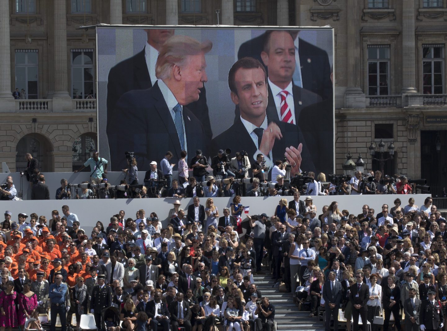 President Donald Trump, pictured on screen with French President Emmanuel Macron and White House Chief of Staff Reince Priebus watch a Bastille Day parade on the Champs Elysees avenue in Paris, July 14, 2017.