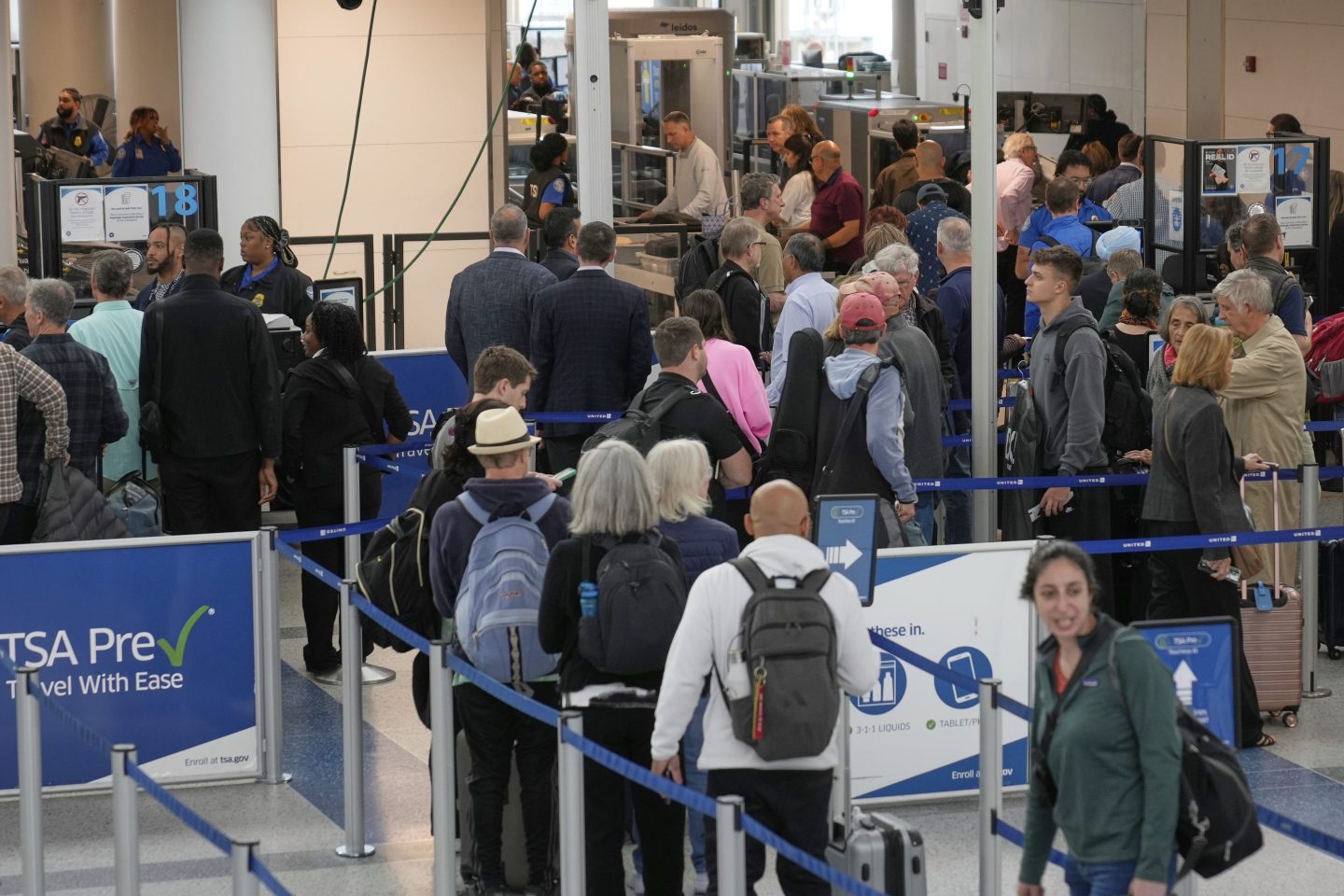 Travelers make their way through security at Newark Liberty International Airport in Newark, N.J., Monday, May 5, 2025.
