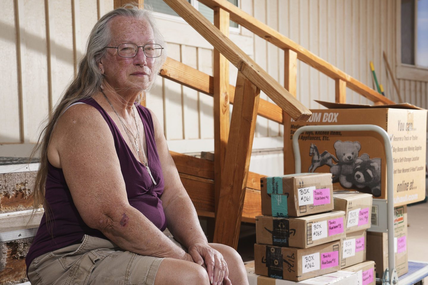 Linda Hilton, a 76-year-old retired office worker, sits in front of her home as she packs up to move Tuesday, May 13, 2025, in Apache Junction, Ariz.