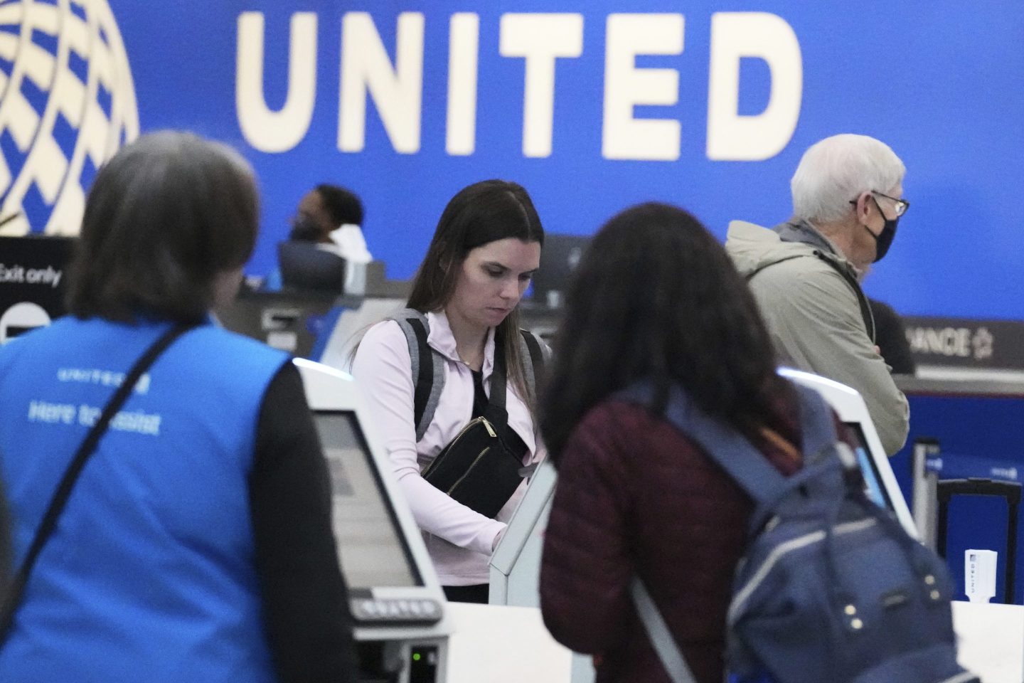Travelers print their boarding passes at kiosks inside of O'Hare International Airport in Chicago, on May 23, 2025.