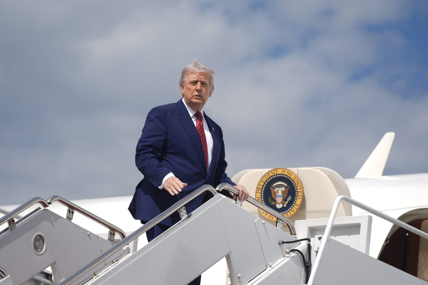 President Donald Trump boards Air Force One to depart Joint Base Andrews, Md., on Friday.