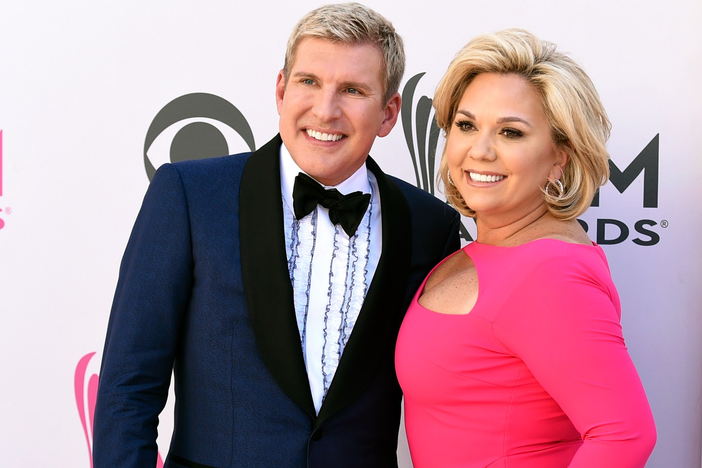 Julie Chrisley, right, and her husband Todd Chrisley pose for photos at the 52nd annual Academy of Country Music Awards April 2, 2017, in Las Vegas.