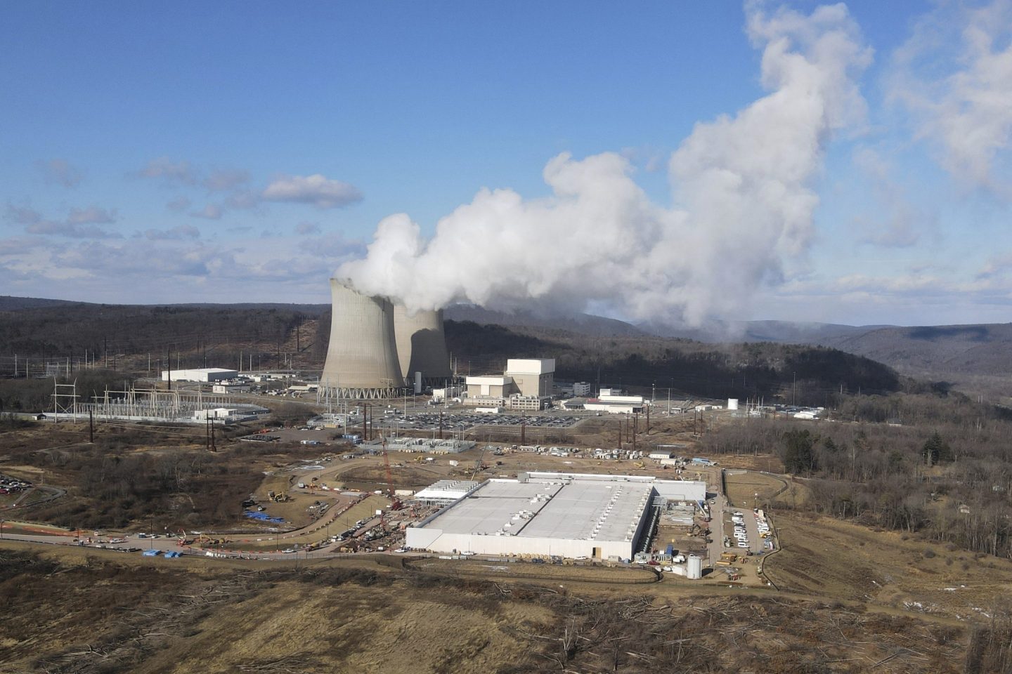 A data center owned by Amazon Web Services, front right, is under construction next to the Susquehanna nuclear power plant in Berwick, Pa., on Jan. 14, 2024.