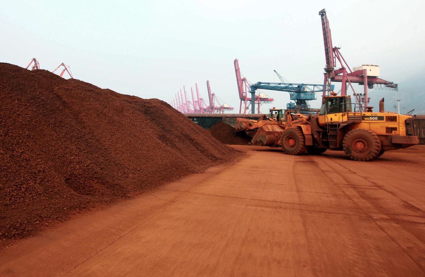 Crane loading a container of rare earth minerals at a Chinese port