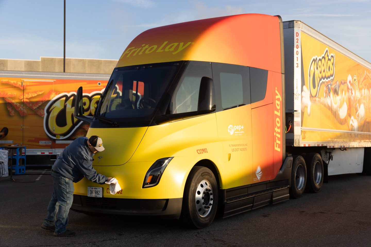 A worker cleans a Tesla Semi electric truck parked outside the Frito-Lay manufacturing facility in Modesto, California, US, on Wednesday, Jan. 18, 2023.