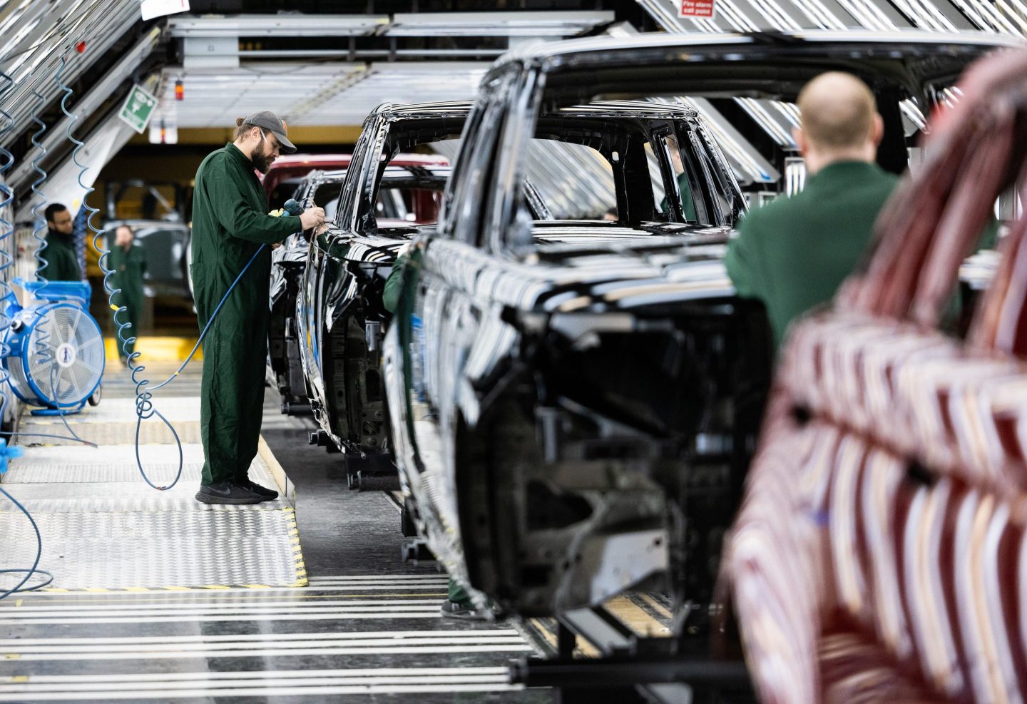 An employee polishes paint on the bodywork of a Range Rover sports utility vehicle (SUV) in the paint shop at Tata Motors Ltd.'s Jaguar Land Rover vehicle manufacturing plant in Solihull, UK, on Friday, Jan. 20, 2023. Tata Motors are due to report their latest results on Wednesday.