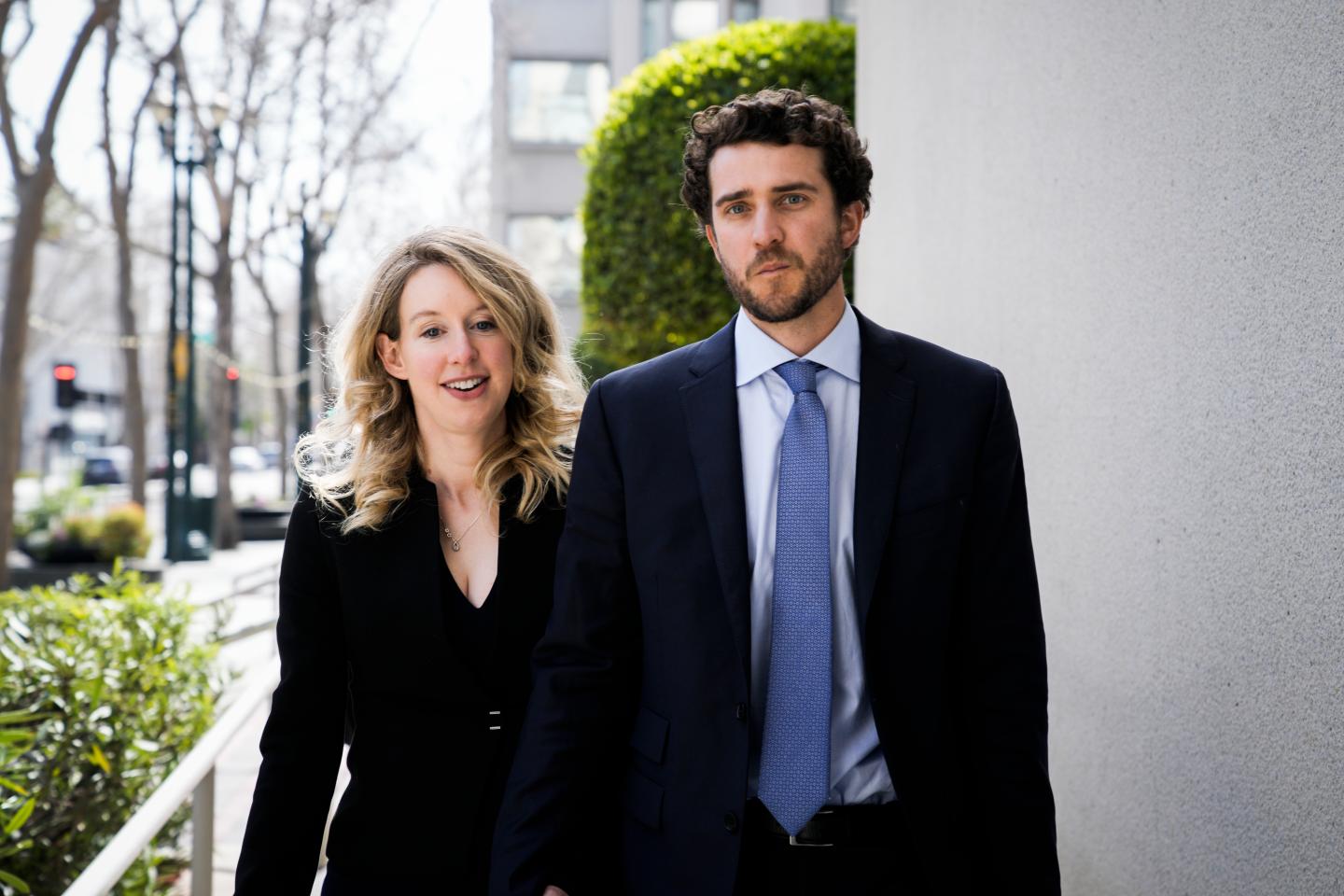 Elizabeth Holmes walking hand in hand with her boyfriend Billy Evans.