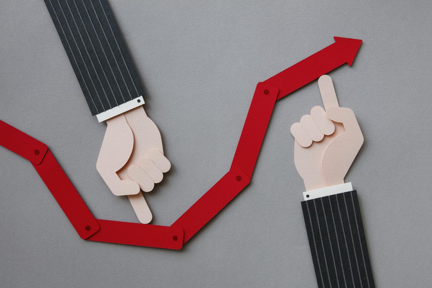 A line graph with illustrated hands pointing down and up