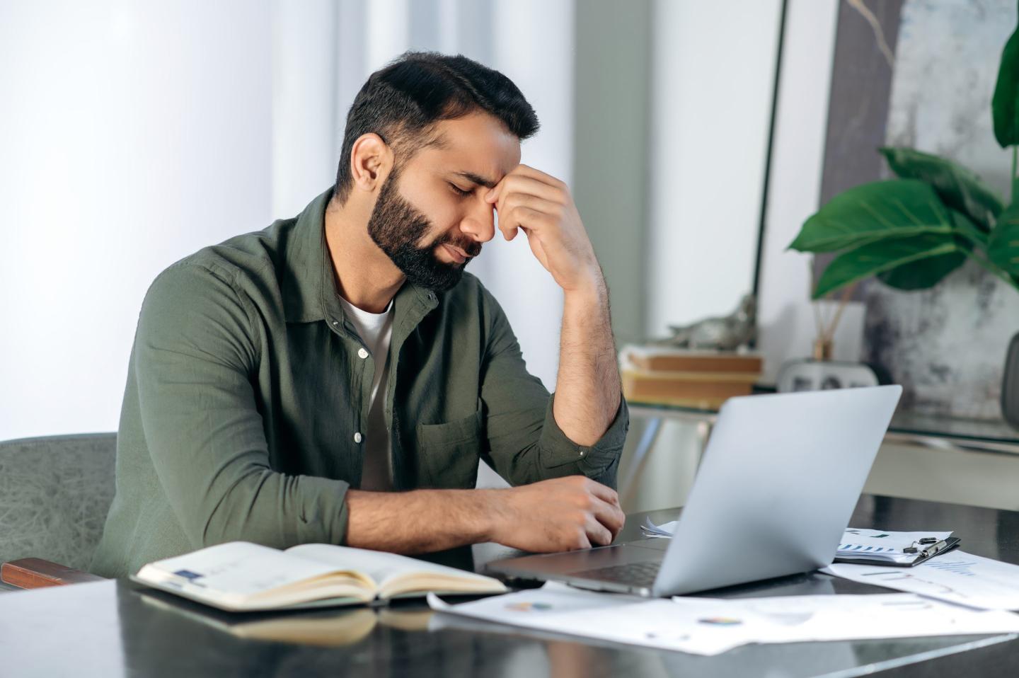 Working man frustrated at his laptop