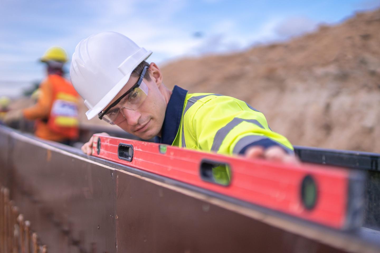 Engineer uses a level on a construction site