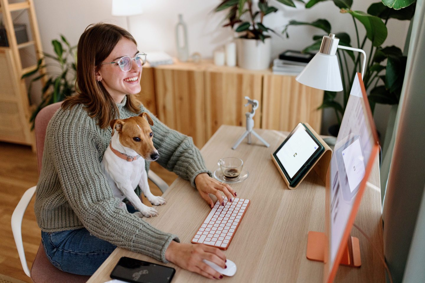 woman sitting at desk with her dog