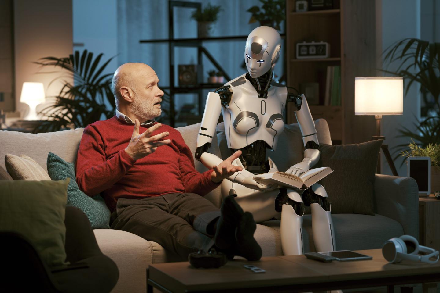 A man and a robot read a book together