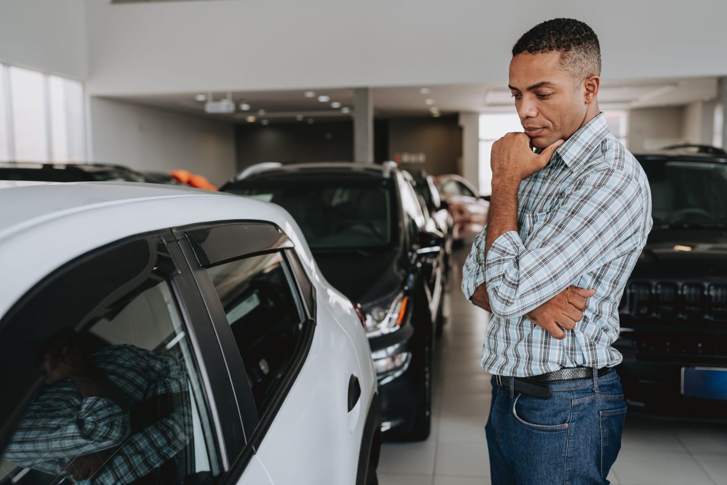 man looking at car to buy