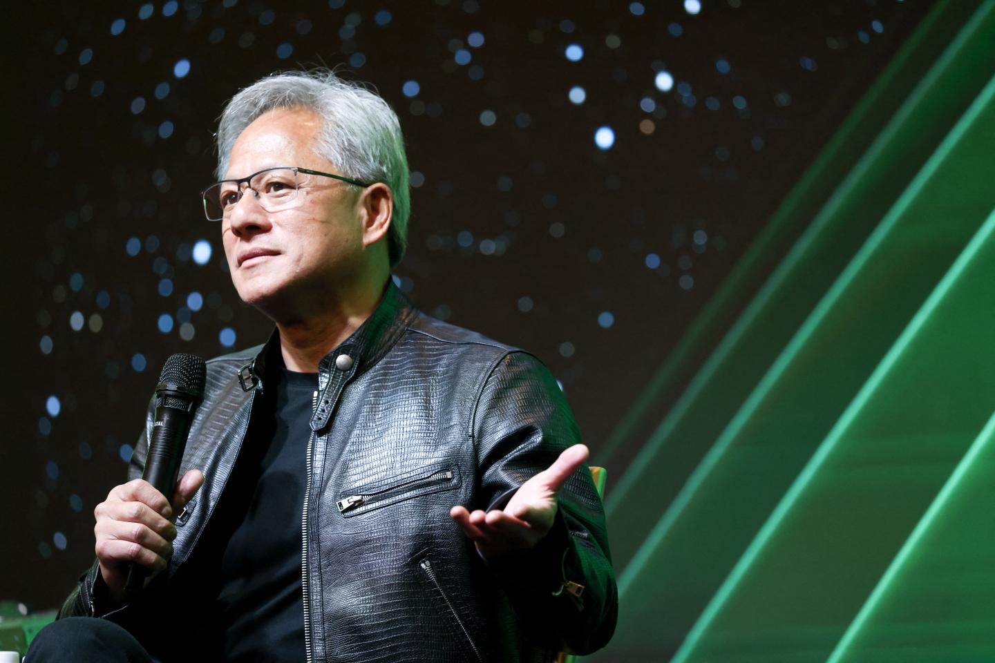 Nvidia CEO Jensen Huang speaking on stage.