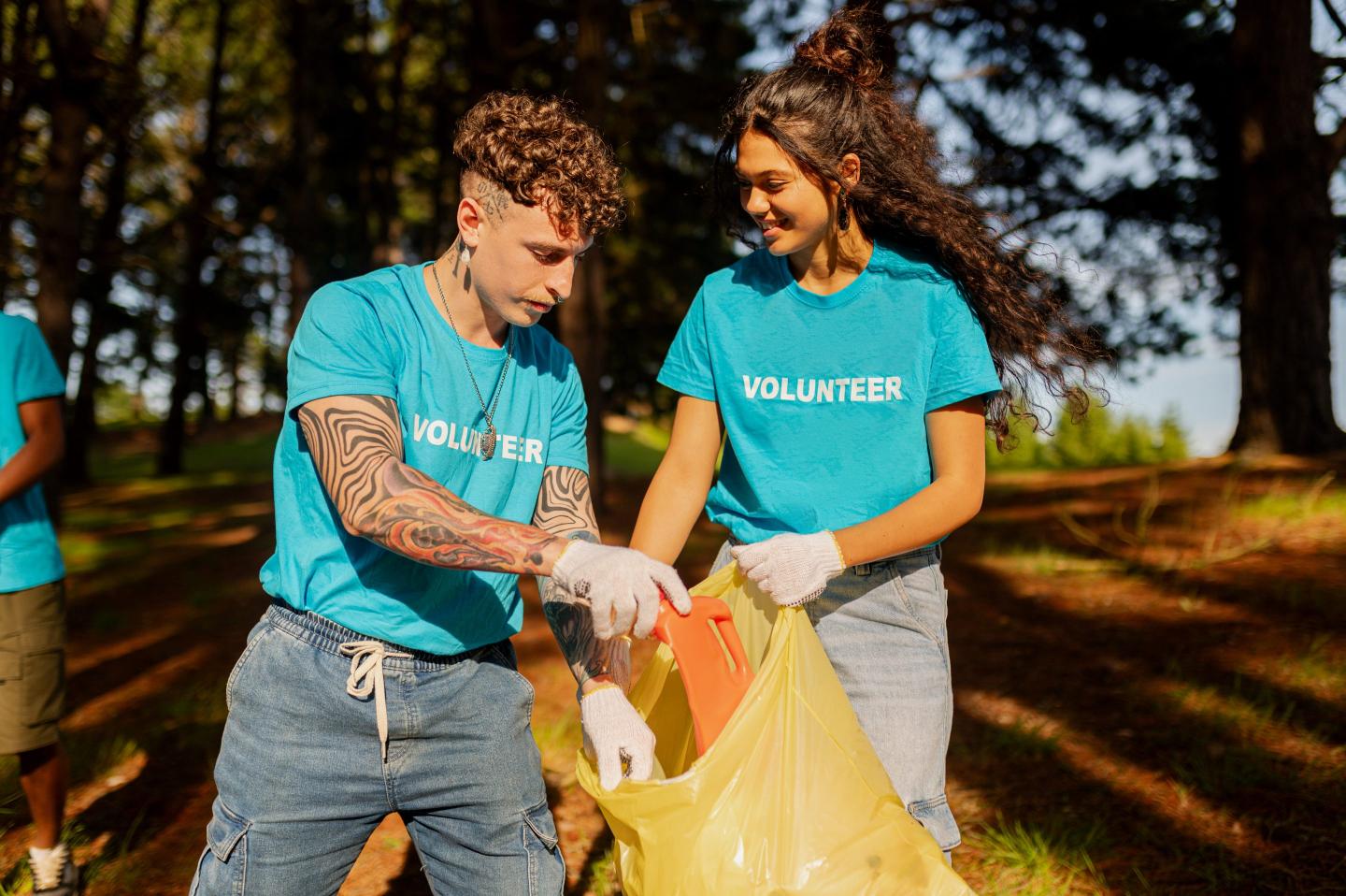 A pair of Gen Zers picking up trash and litter