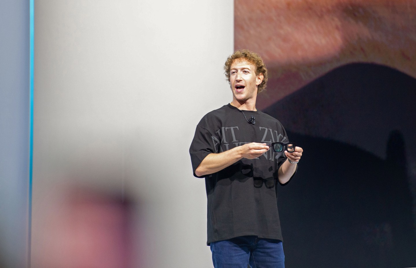 Mark Zuckerberg speaking while wearing an oversized black t-shirt.