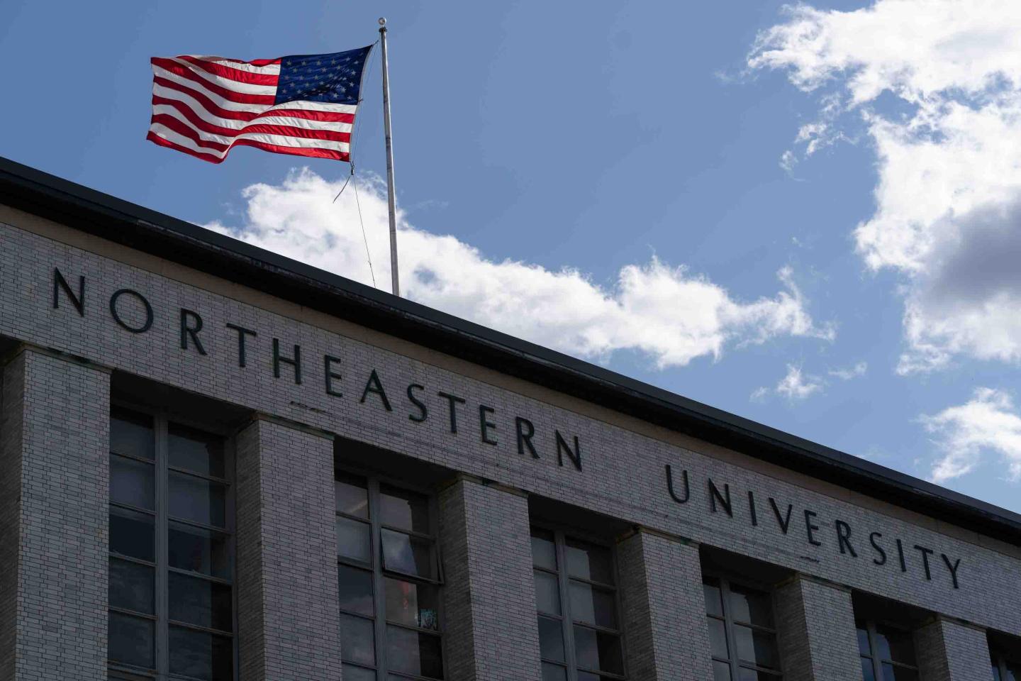 An image of Northeastern University with an American flag.