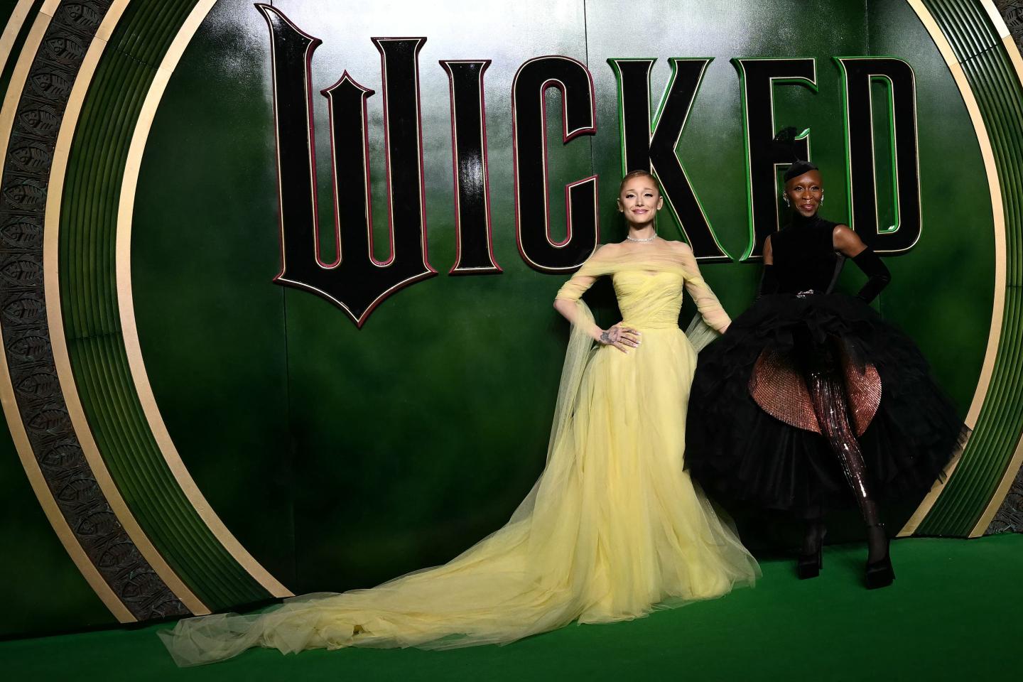 US singer Ariana Grande (L) and Nigerian-British actor Cynthia Erivo (R) pose on a carpet