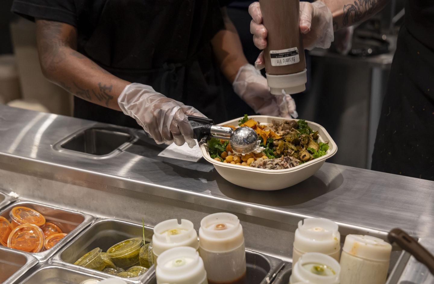 Sweetgreen workers making a salad
