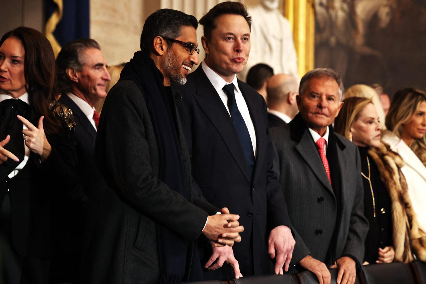 Sundar Pichai and Elon Musk stand in a crowd