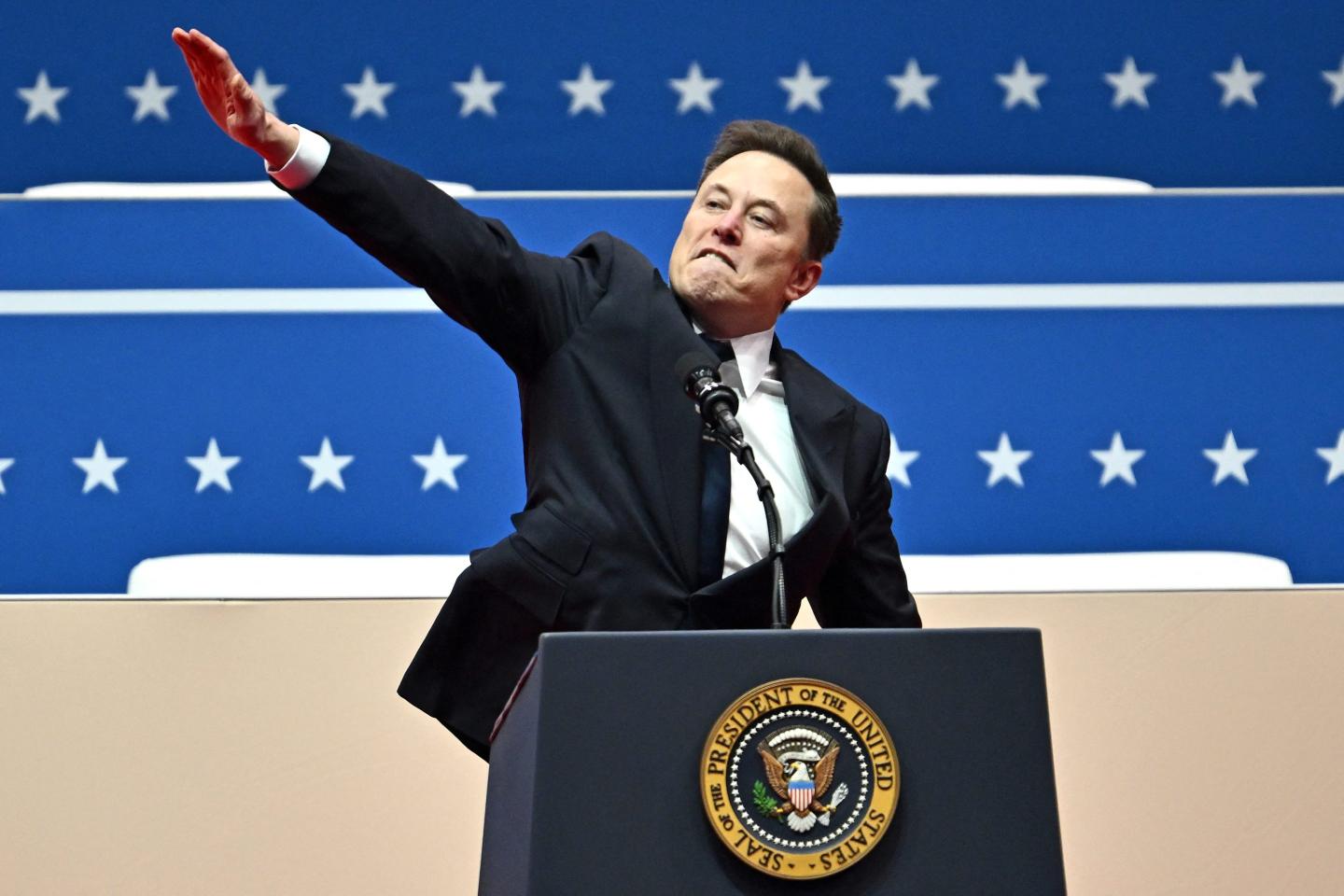 Tesla and SpaceX CEO Elon Musk gestures as he speaks during the inaugural parade inside Capitol One Arena, in Washington, DC, on January 20, 2025. (