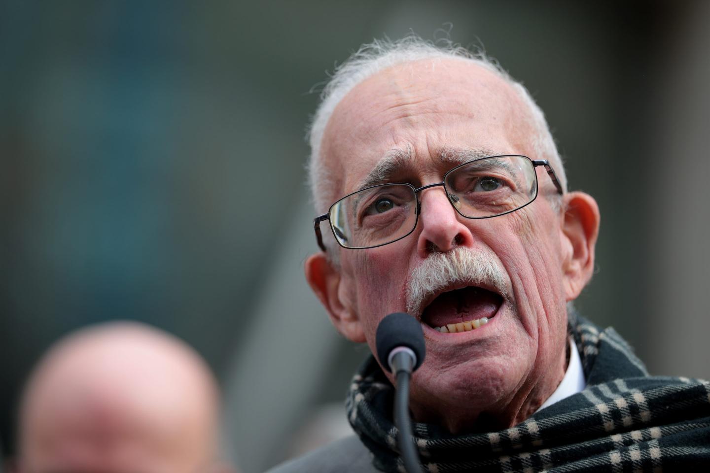 Gerry Connolly shouts into a microphone at a rally against Elon Musk and DOGE