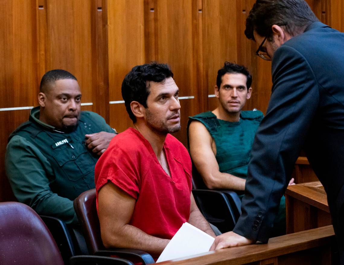Oren Alexander, 37, center, and his twin brother, Alon, center-right, speak to their attorney Joel Denaro during their bond hearing at the Richard E. Gerstein Justice Building on Dec. 12, 2024, in Miami.