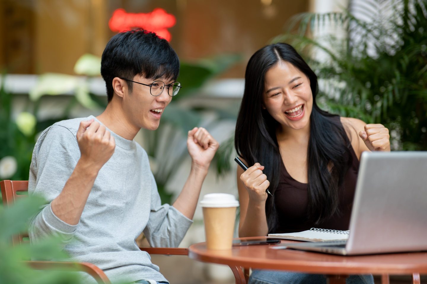 Friends cheer looking at a computer