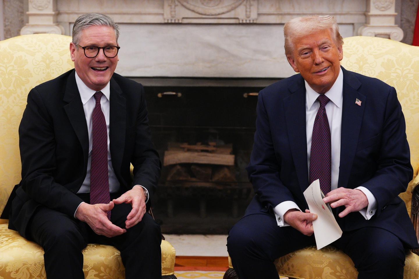 UK Prime Minister Sir Keir Starmer hands an invitation from King Charles III for a second state visit to U.S. President Donald Trump at the White House.