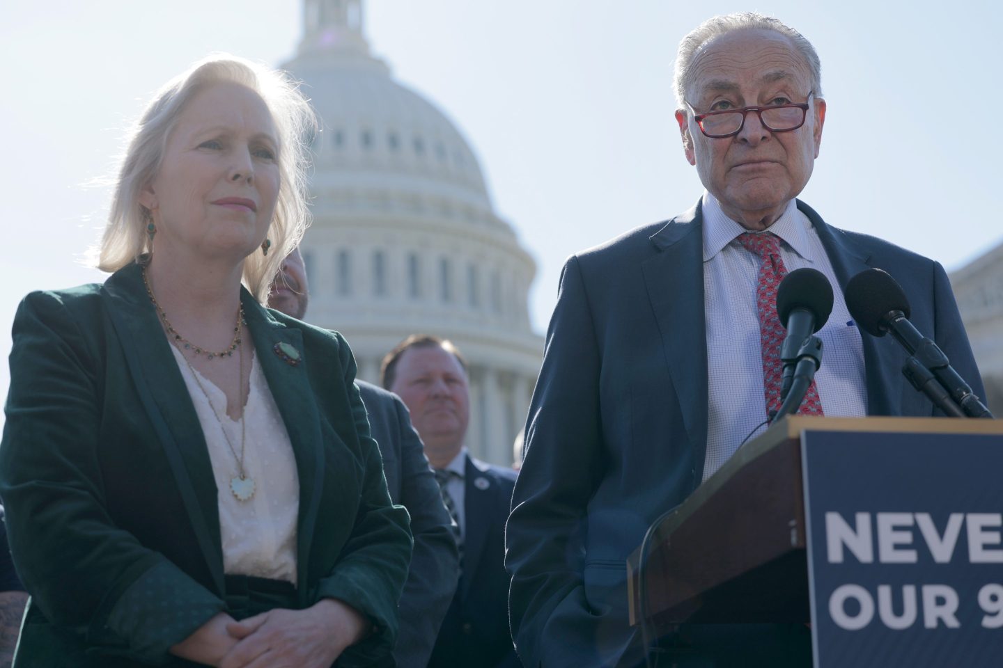 Kirsten Gillibrand stands next to Chuck Schumer at a press conference
