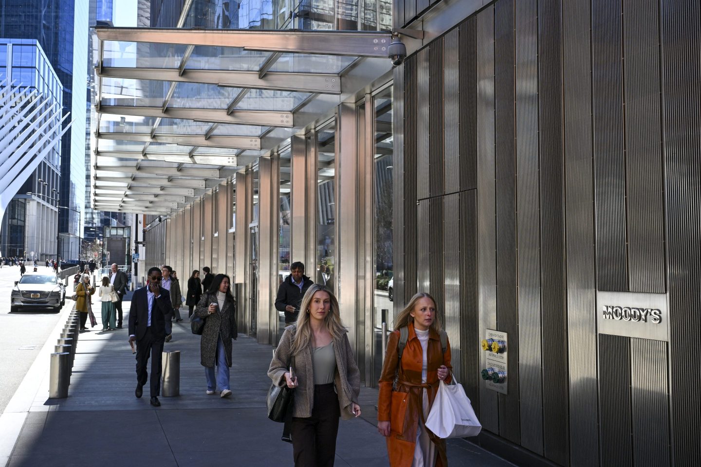 people walking by wall street banks