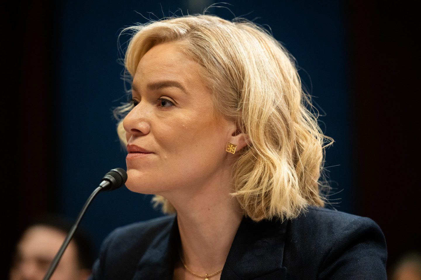 NPR CEO Katherine Maher speaks into a microphone