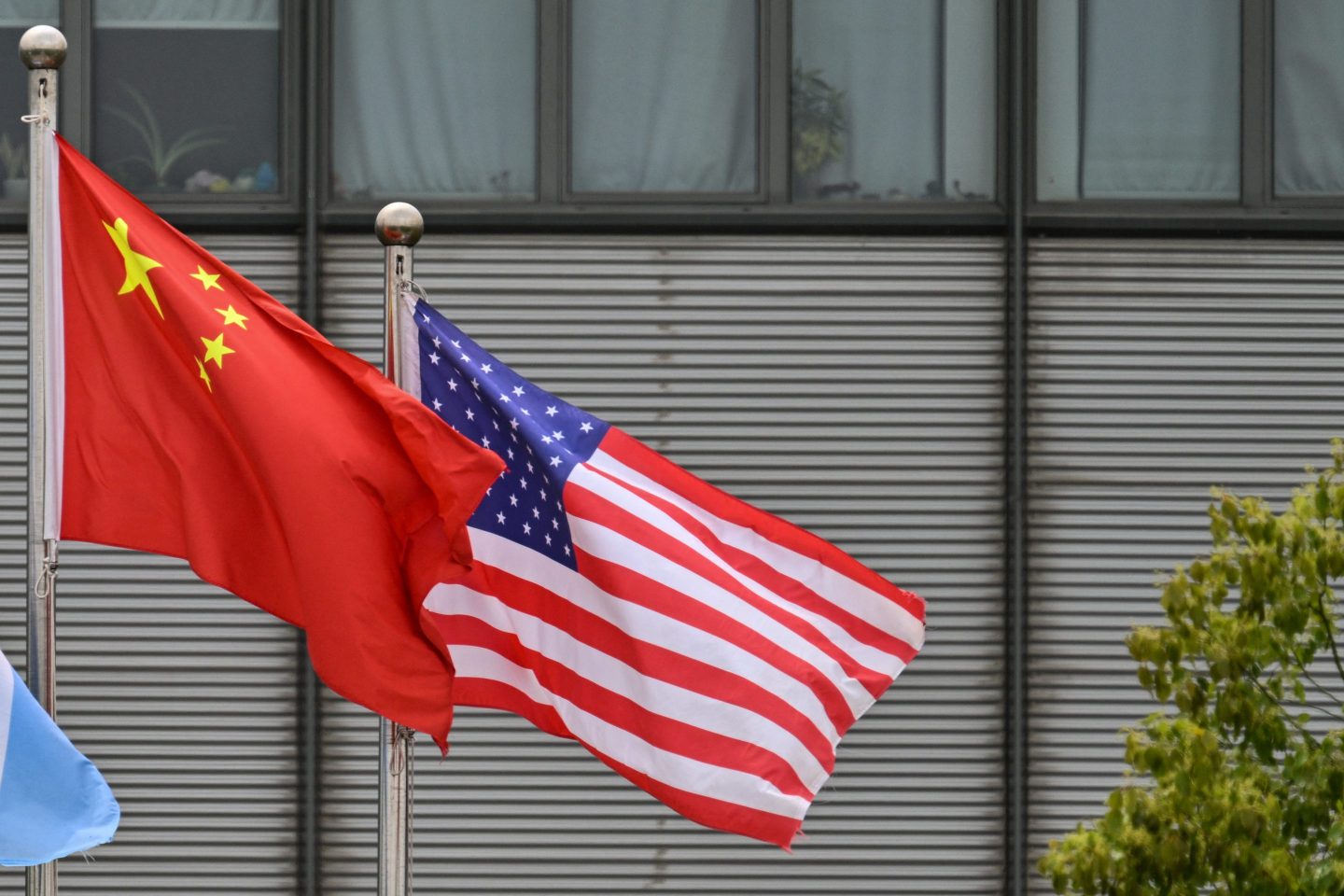 Chinese and U.S. flags flutter in the wind at the Boeing Shanghai Aviation Services facilities near the Shanghai Pudong International Airport in Shanghai on April 17, 2025.