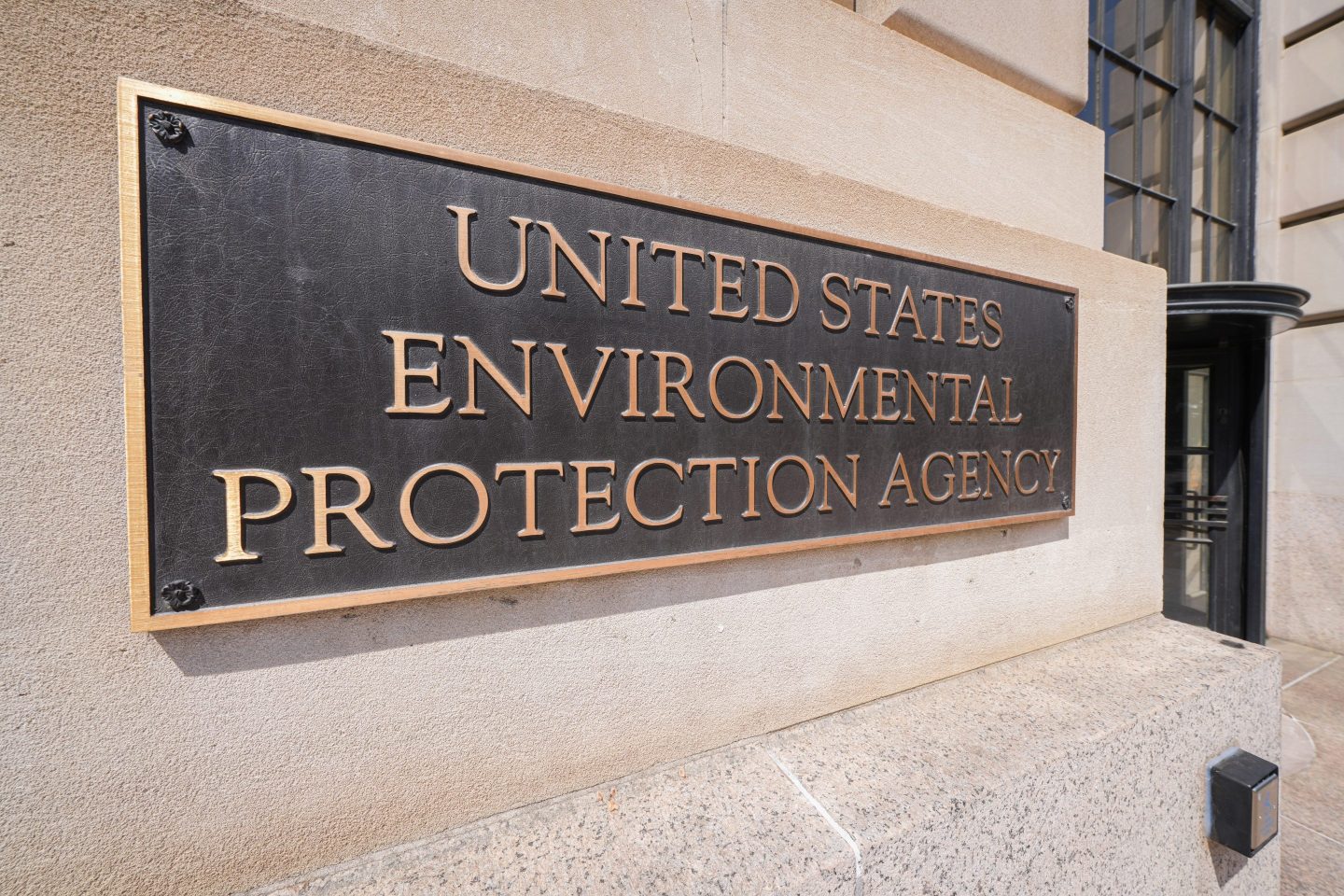 A bronze sign marks the location of the U.S. Environmental Protection Agency (EPA) headquarters
