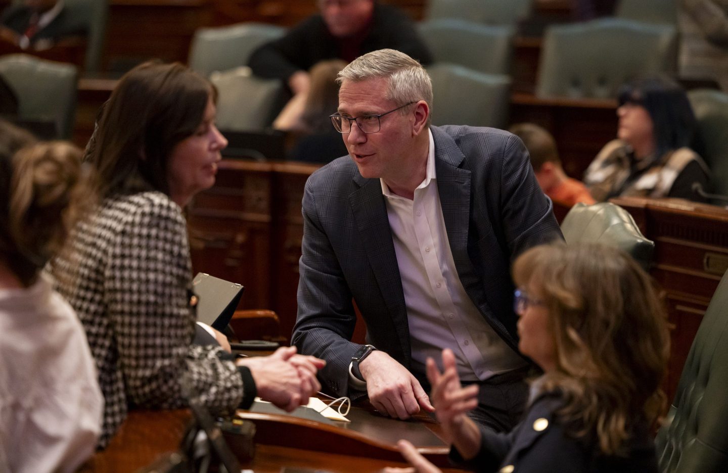 Illinois State Treasurer Michael Frerichs talks with legislators on the House floor at the state Capitol in Springfield, Illinois, on Jan. 7, 2025.