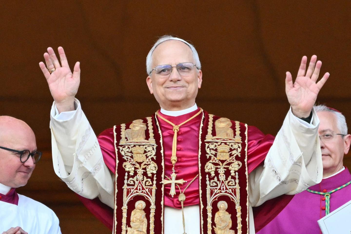 Pope Leo XIV, Robert Prevost, waves his hands to the crowd