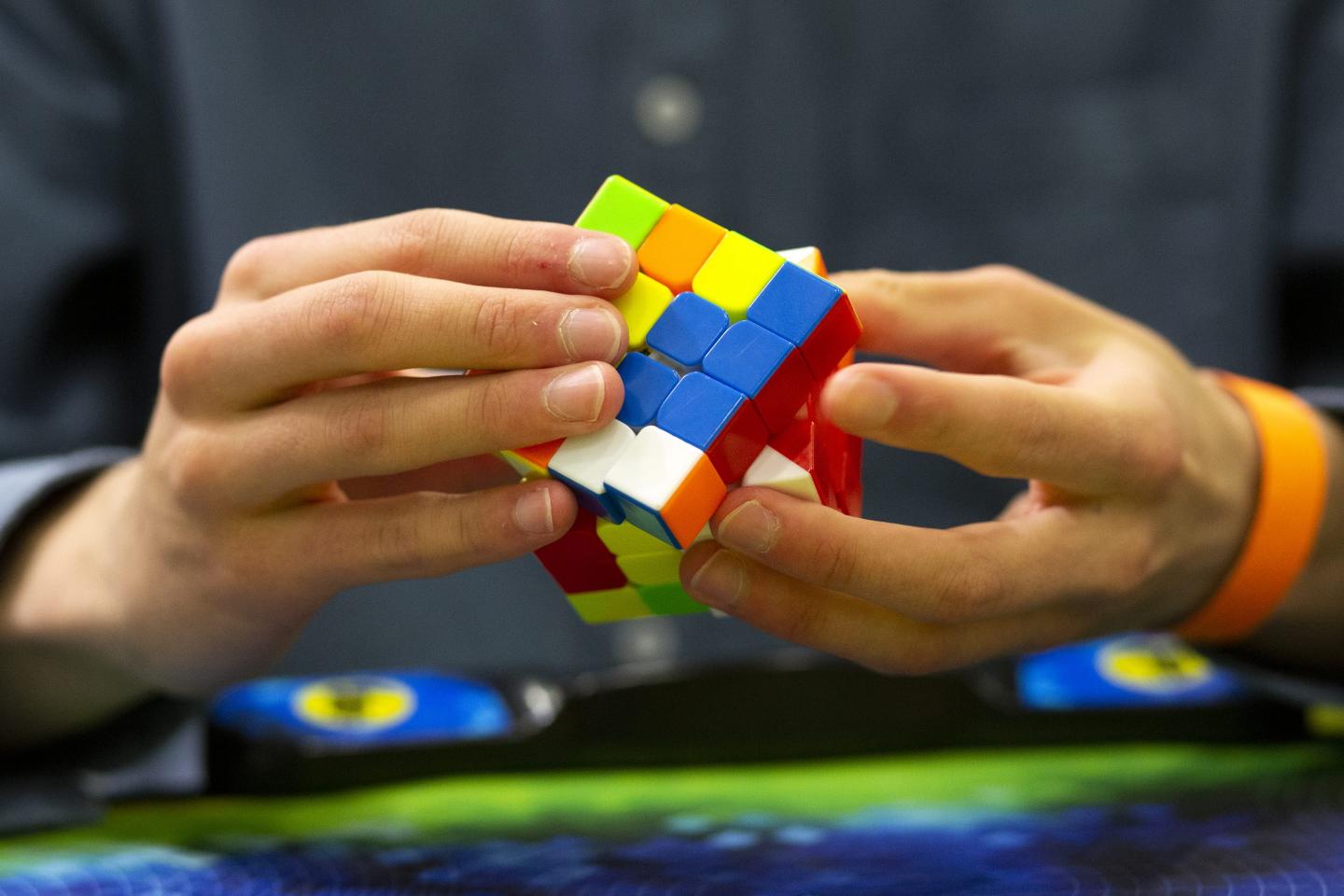hands holding a rubik's cube