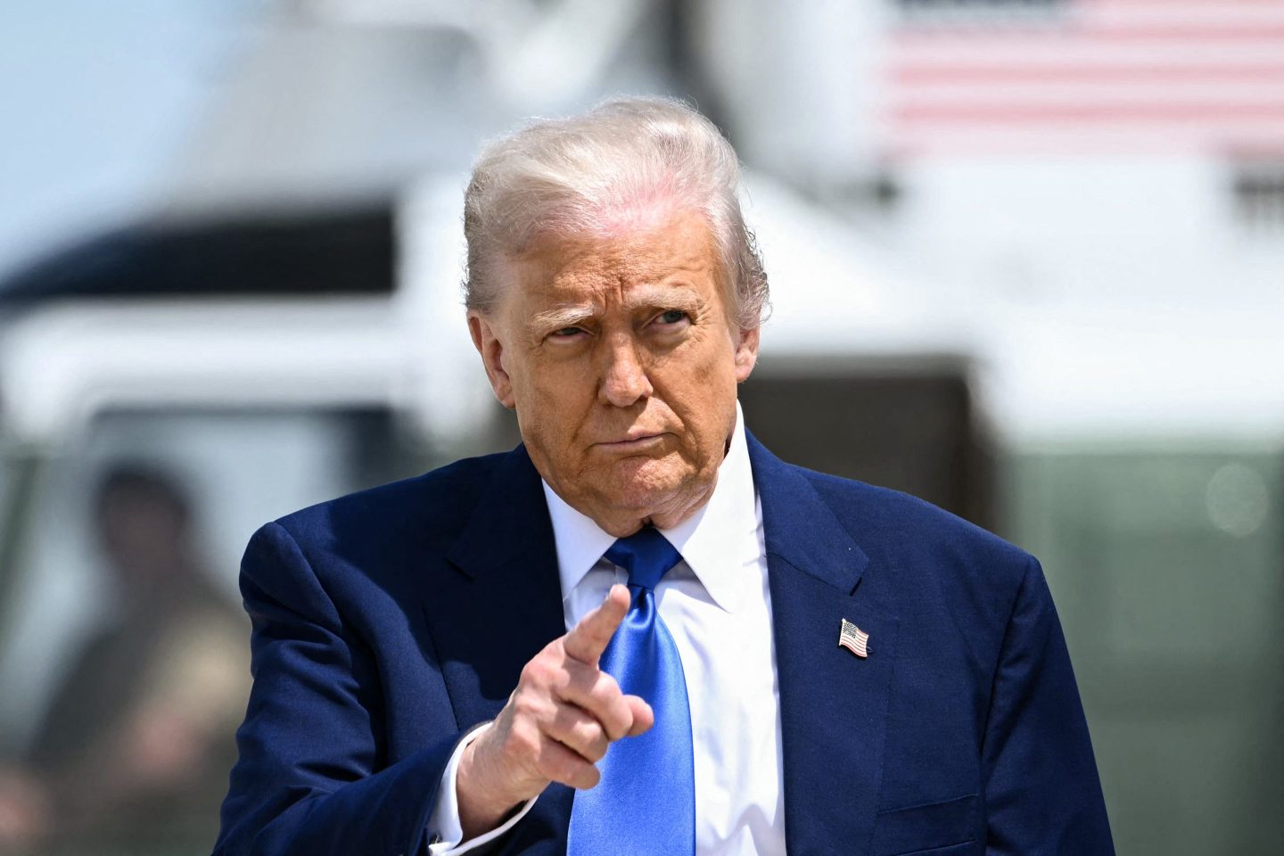 US President Donald Trump gestures as he walks to board Air Force One