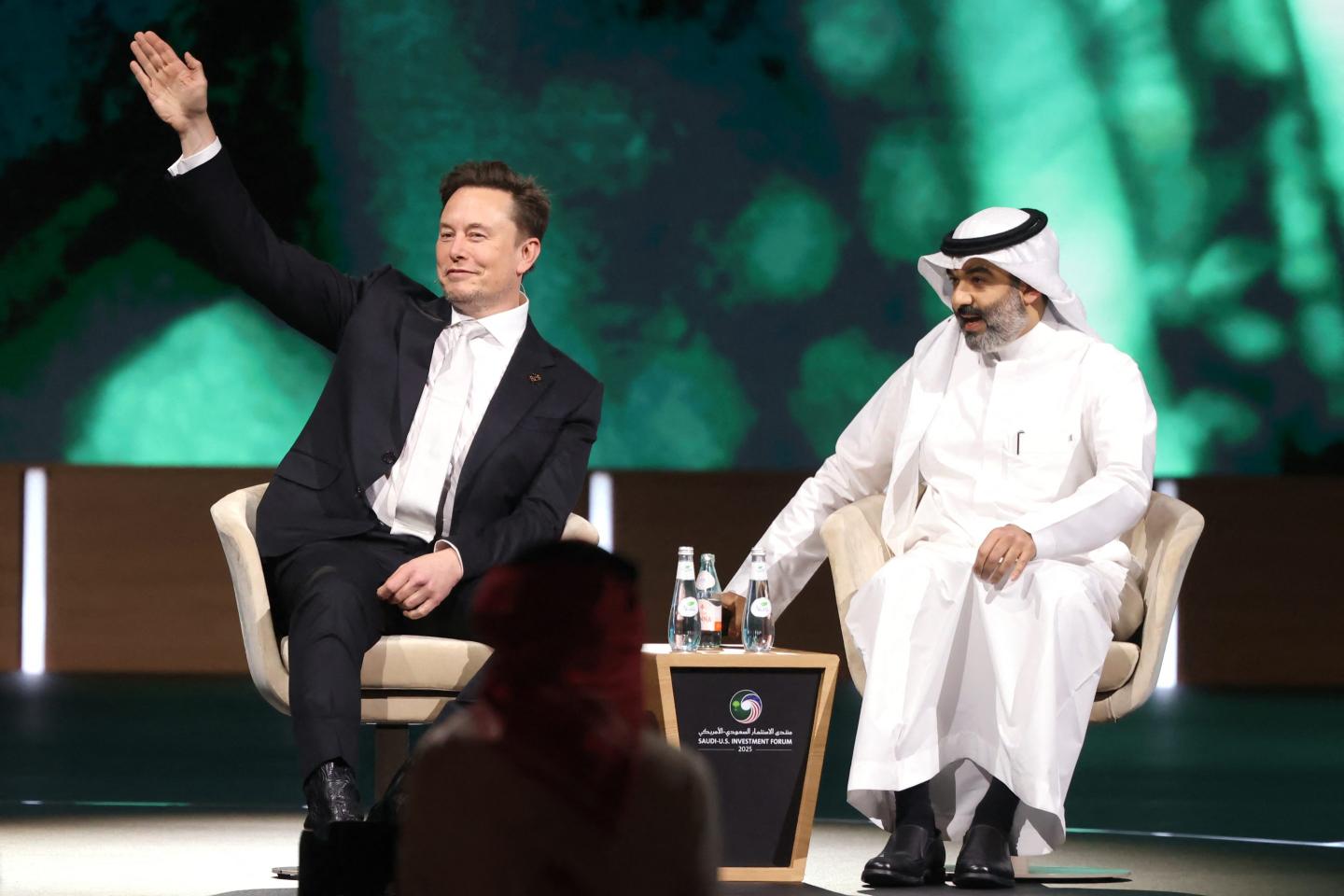 Elon Musk waves