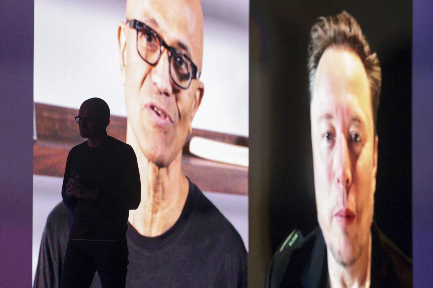 Microsoft Chairman and Chief Executive Officer Satya Nadella is silhouetted as a pre-recorded interview with Elon Musk