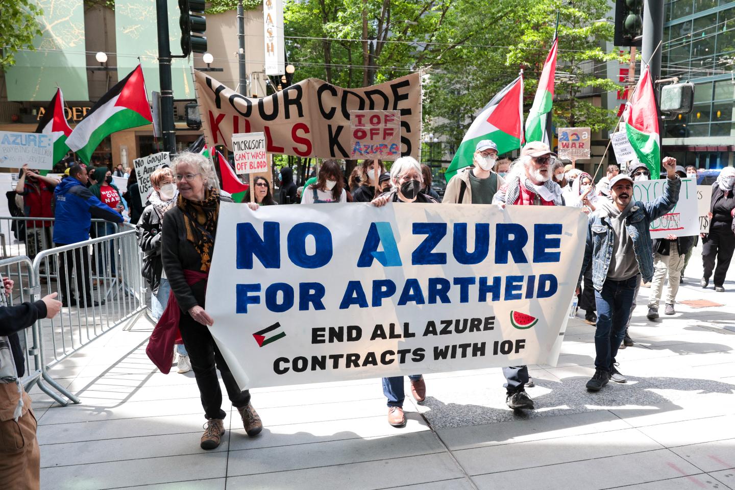Protesters hold a sign that says "No Azure For Apartheid"