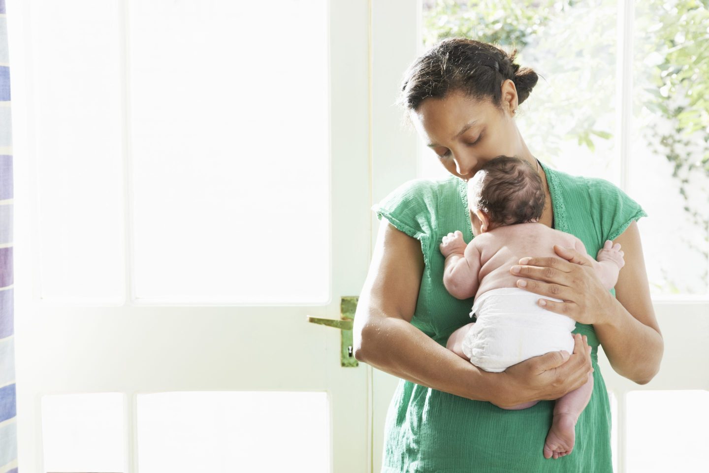 Mother holding a baby in a diaper