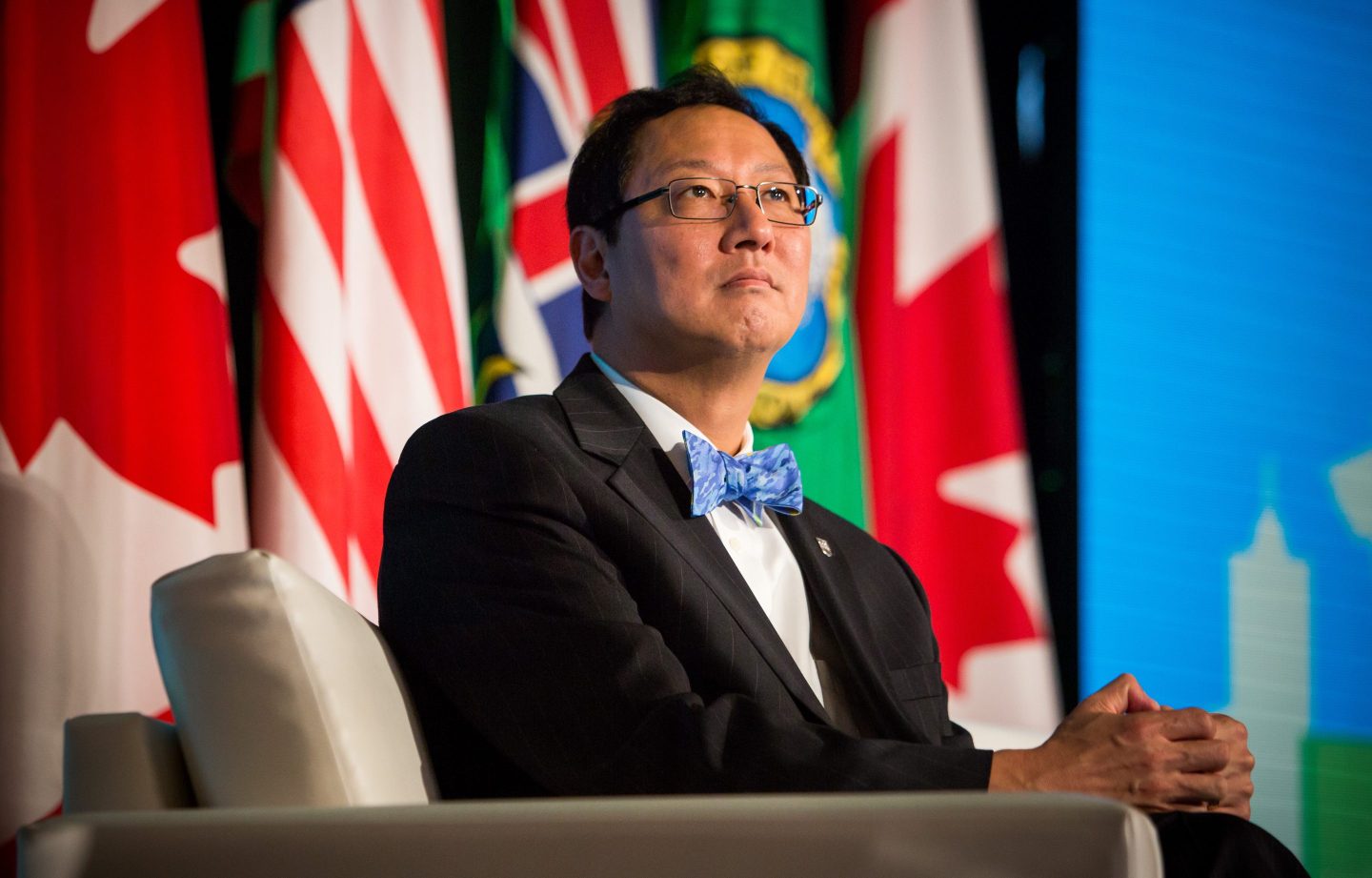 Santa Ono clasps his hands