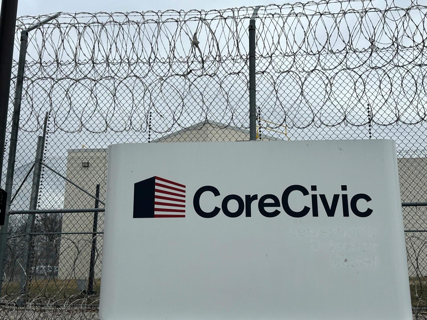 CoreCivic's logo in front of a prison
