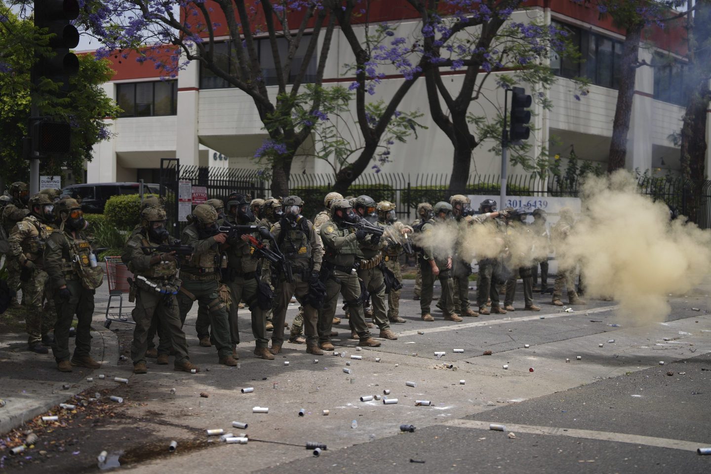 Border Patrol personnel deploy tear gas during a demonstration over the dozens detained in an operation by federal immigration authorities a day earlier in Paramount near Los Angeles on Saturday.