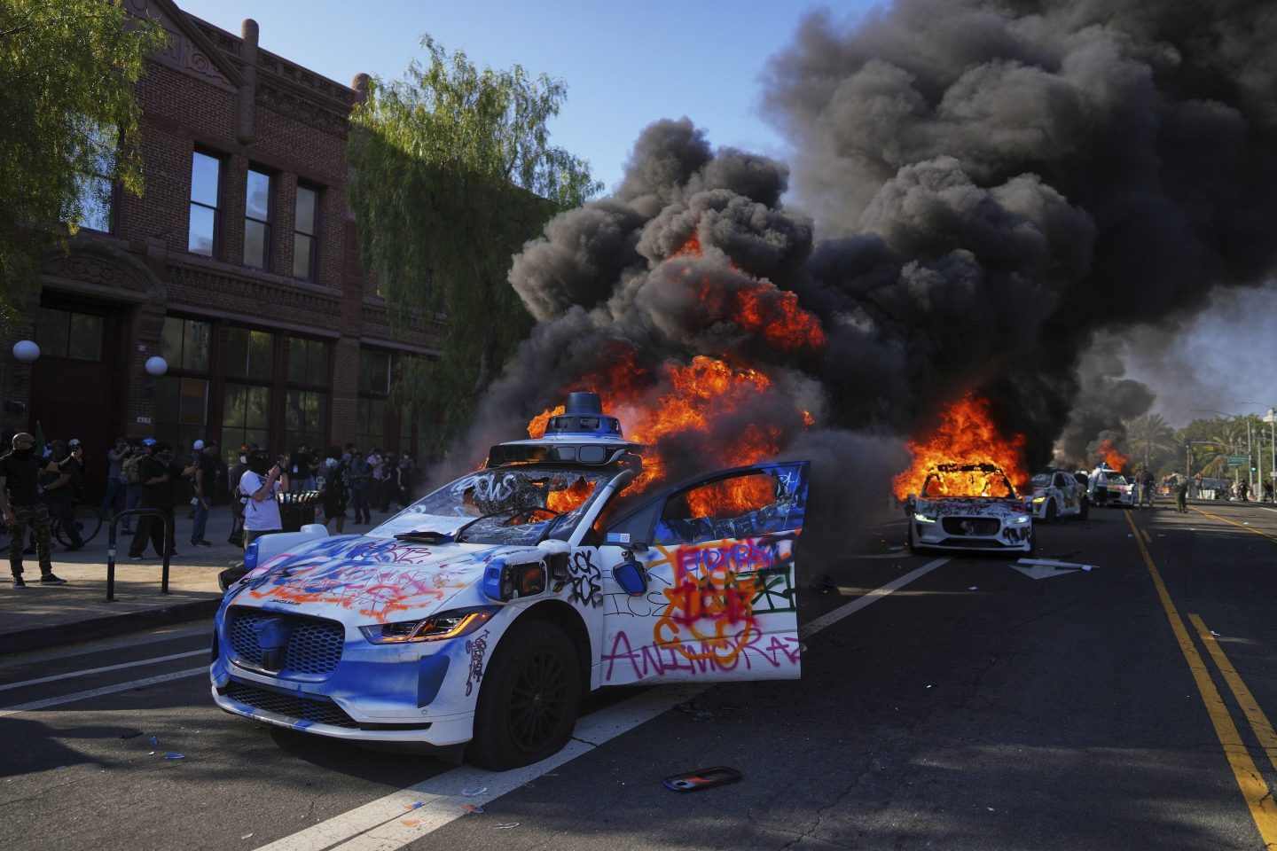 Multiple Waymo taxis burn near the Metropolitan Detention Center of downtown Los Angeles, on June 8, 2025.