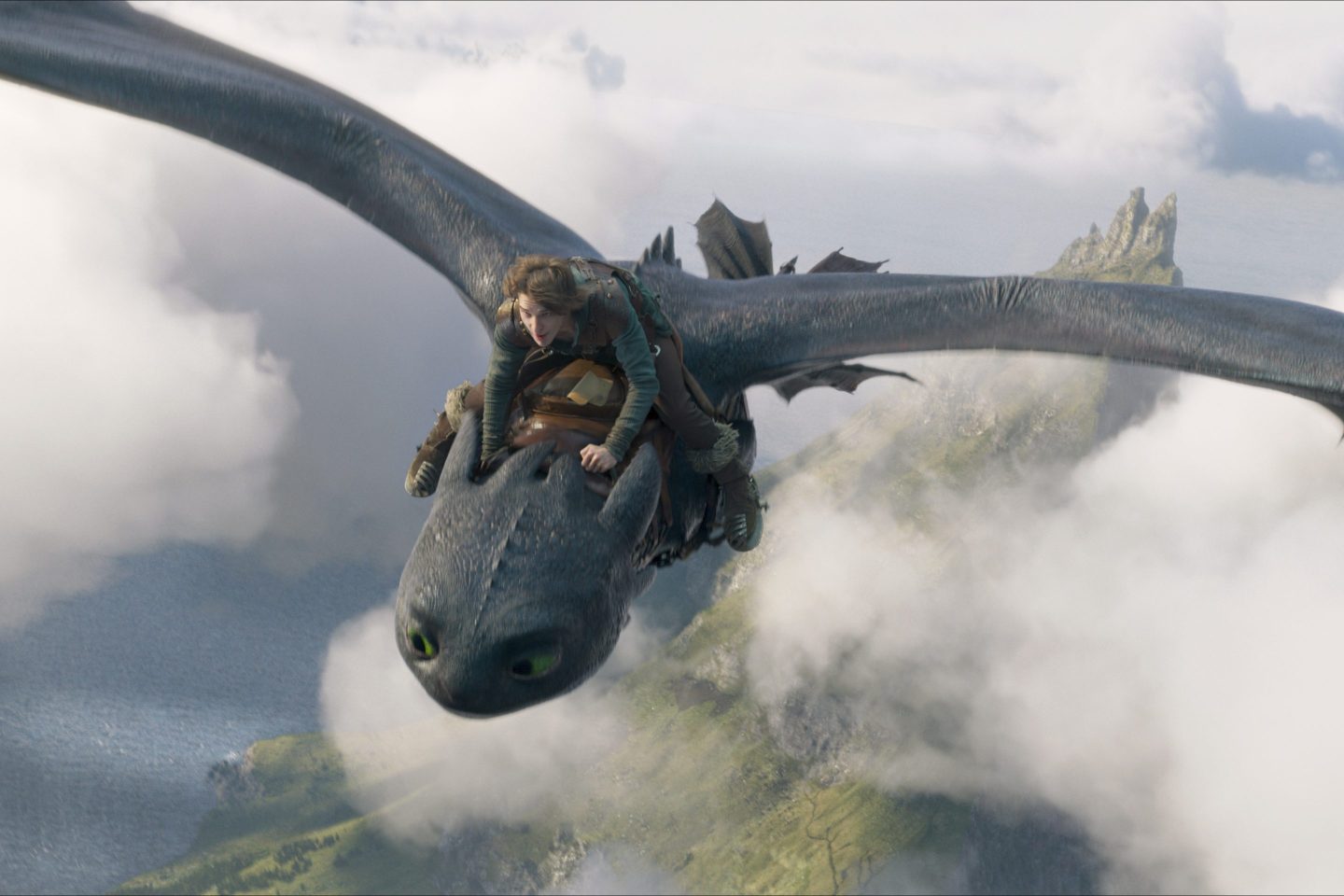Mason Thames, as Hiccup, riding the Night Fury dragon Toothless in a scene from "How to Train Your Dragon.".